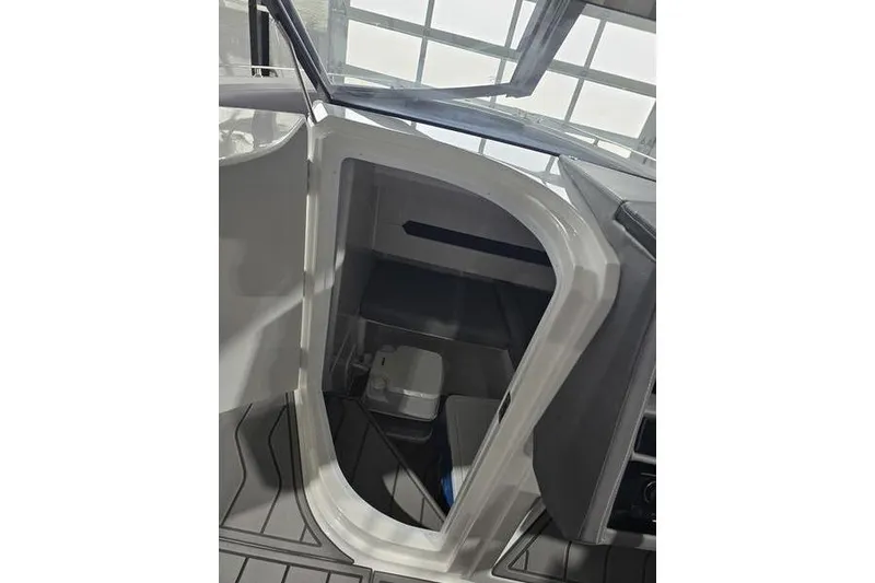 Slide: The Image of 2026 Cobalt A29 boat in showroom, sleek design, white and blue accents, on trailer. - 7