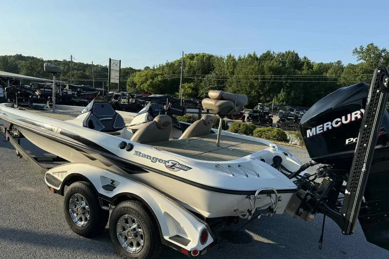 Slide: The Image of 2012 Ranger Z521 Comanche boat with Mercury engine on a trailer, parked outdoors. - 6