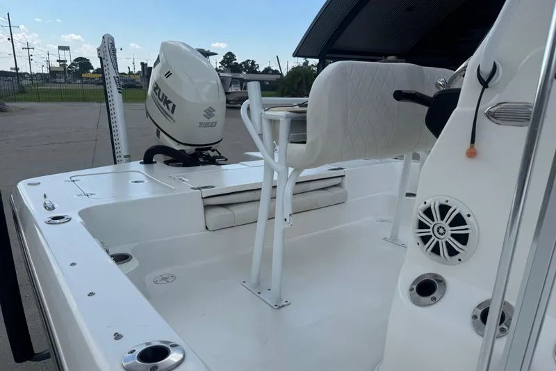 Slide: The Image of 2019 Epic E2 2100 Bay boat with Suzuki 150 engine, white interior, and fishing rod holders. - 14