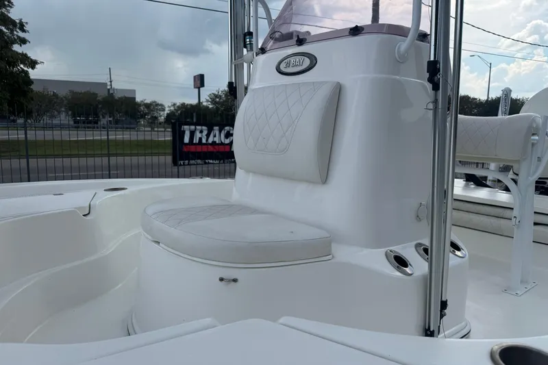 Slide: The Image of 2019 Epic E2 2100 Bay boat interior with cushioned seating and rod holders. - 18