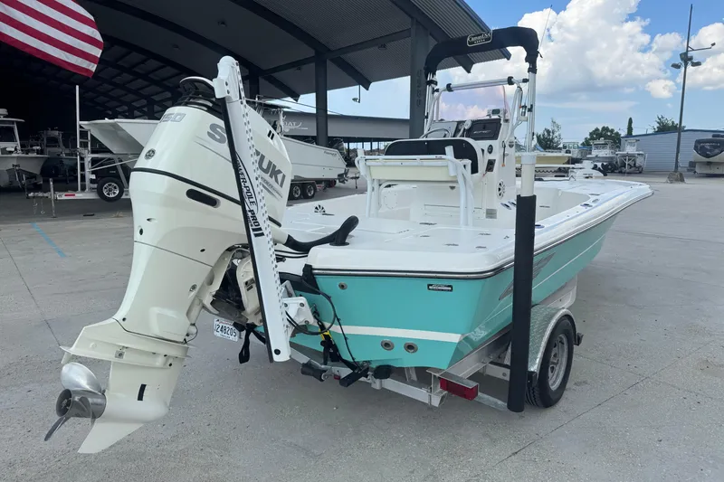 Slide: The Image of 2019 Epic E2 2100 Bay boat with Suzuki outboard motor on trailer, parked outdoors. - 4