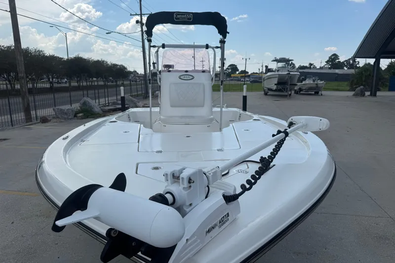 Slide: The Image of 2019 Epic E2 2100 Bay boat with Minn Kota trolling motor, parked outdoors. - 8