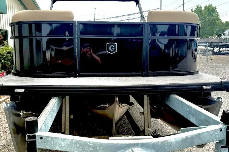 Slide: The Image of 2026 Godfrey Xperience EX2286SFLX pontoon boat on trailer, rear view. - 2