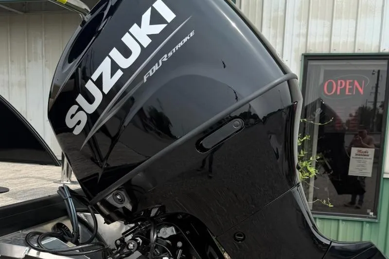 Slide: The Image of Suzuki Four Stroke engine on 2026 Godfrey Xperience EX2286SFLX boat, outdoor setting. - 4