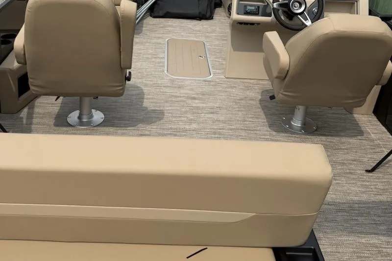 Slide: The Image of Interior of 2026 Godfrey Xperience EX2286SFLX boat with beige seating and steering console. - 6