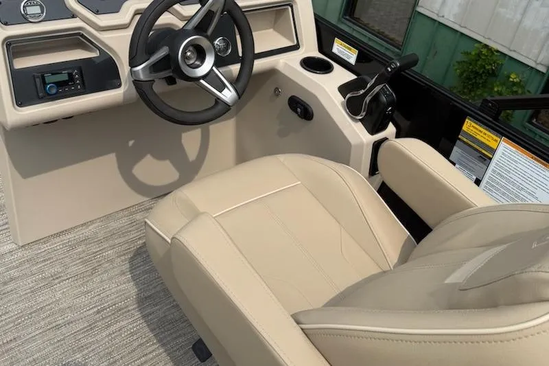 Slide: The Image of 2026 Godfrey Xperience EX2286SFLX boat interior with steering wheel and beige seating. - 7