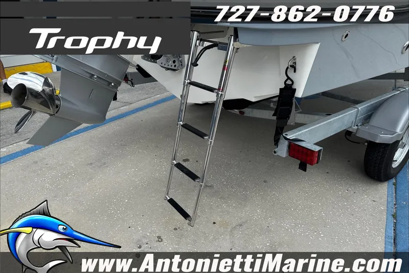 Slide: The Image of 2026 Trophy T22CC Center Console boat on trailer with ladder and propeller. - 11
