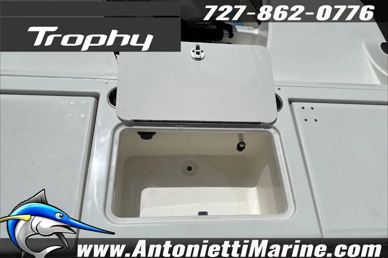 Slide: The Image of 2026 Trophy T22CC Center Console boat deck with storage compartment open. - 15