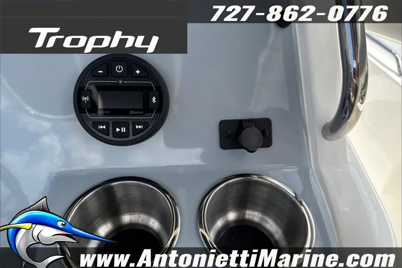 Slide: The Image of 2026 Trophy T22CC Center Console dashboard with Bluetooth controls and cup holders. - 23