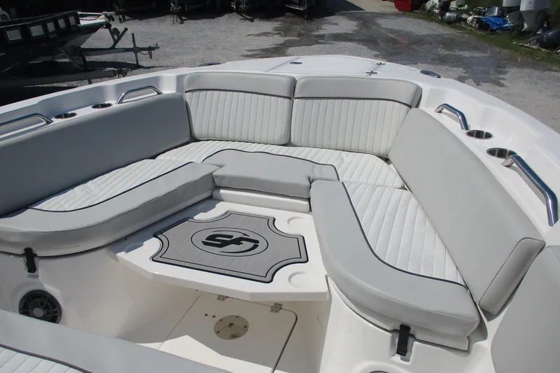 Slide: The Image of 2024 Sea Fox 268 Commander boat interior with cushioned seating and cup holders. - 13