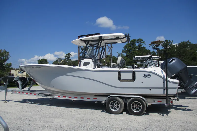 Slide: The Image of 2024 Sea Fox 268 Commander boat on trailer under clear blue sky. - 2