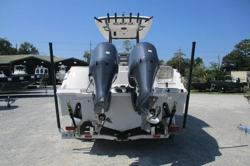 Slide: The Image of 2024 Sea Fox 268 Commander boat with dual outboard motors, parked on gravel lot. - 4