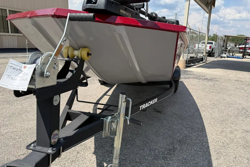 Slide: The Image of 2019 Tracker Pro 170 boat on trailer, parked outdoors under a clear sky. - 6