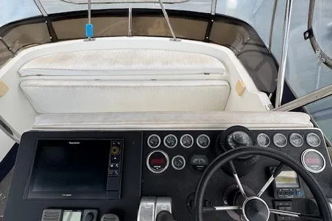 Slide: The Image of 1992 Mediterranean 38 Convertible boat dashboard with steering wheel and navigation instruments. - 11