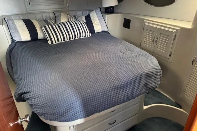 Slide: The Image of Cozy bedroom in 1992 Mediterranean 38 Convertible yacht with blue bedding and striped pillows. - 16