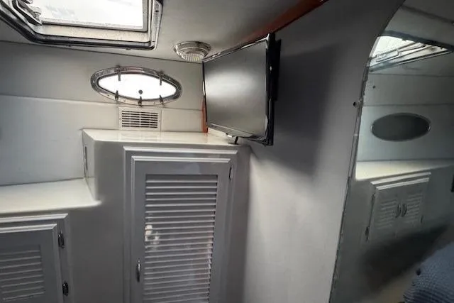 Slide: The Image of Interior of 1992 Mediterranean 38 Convertible yacht with TV and storage cabinets. - 17