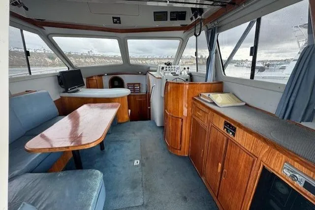 Slide: The Image of Interior of 1992 Mediterranean 38 Convertible yacht with wood furnishings and panoramic windows. - 22