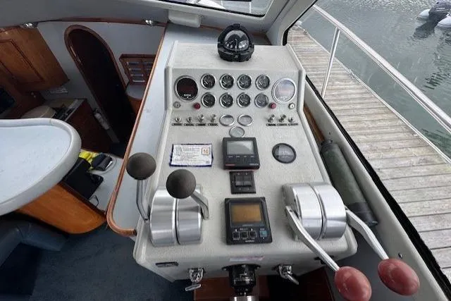 Slide: The Image of Control panel of a 1992 Mediterranean 38 Convertible boat, featuring gauges and levers. - 23