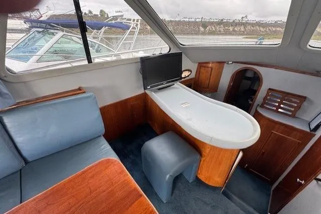 Slide: The Image of Interior of 1992 Mediterranean 38 Convertible yacht with seating and small table. - 25