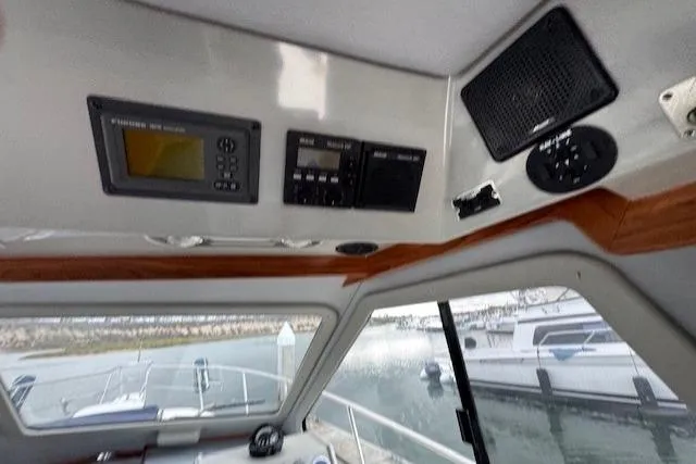 Slide: The Image of Interior view of a 1992 Mediterranean 38 Convertible boat with control panel and speaker. - 27