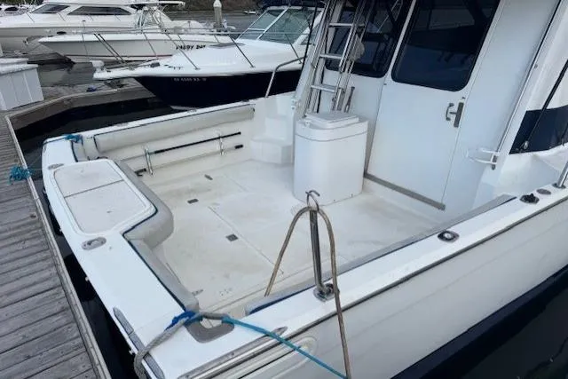 Slide: The Image of 1992 Mediterranean 38 Convertible yacht docked, featuring spacious deck and sleek design. - 3