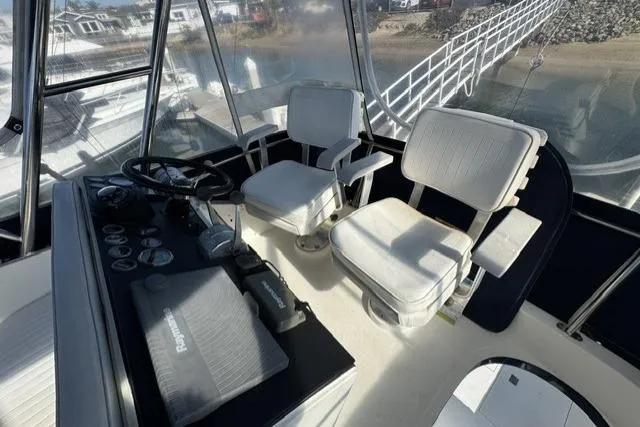 Slide: The Image of Interior of 1992 Mediterranean 38 Convertible yacht with wood furnishings and panoramic windows. - 36