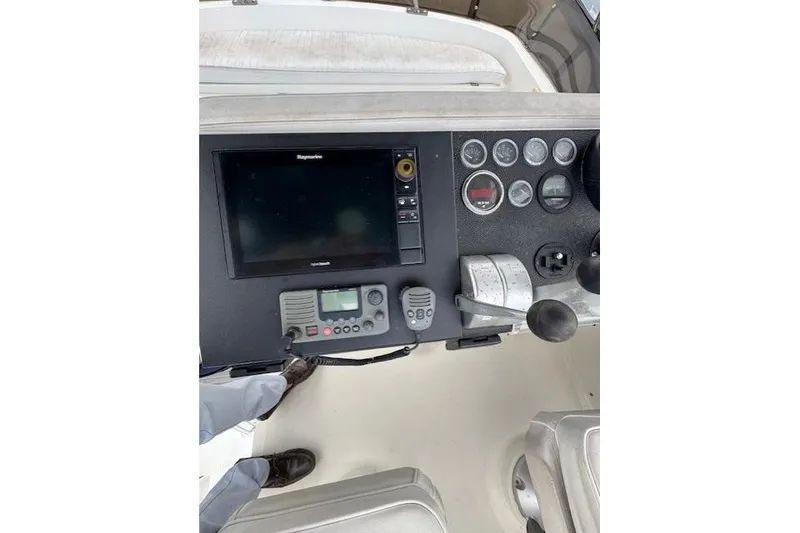 Slide: The Image of Interior of 1992 Mediterranean 38 Convertible yacht with blue seating and wooden table. - 38