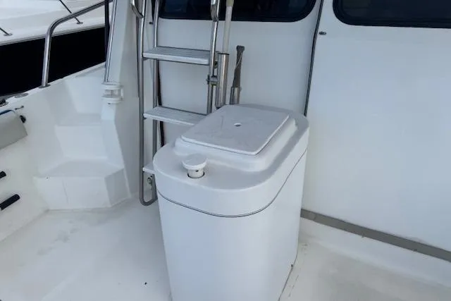 Slide: The Image of 1992 Mediterranean 38 Convertible yacht deck with ladder and storage compartment. - 4