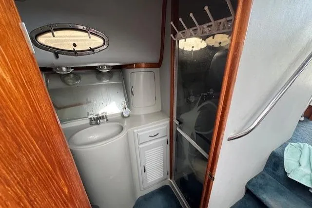 Slide: The Image of Interior view of a 1992 Mediterranean 38 Convertible boat with fishing rods on ceiling rack. - 43