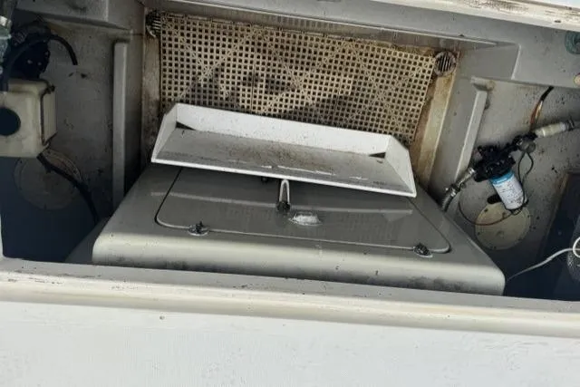 Slide: The Image of Engine compartment of a 1992 Mediterranean 38 Convertible boat, showing mechanical components. - 47