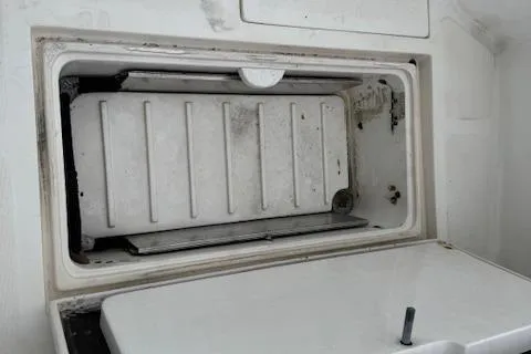 Slide: The Image of Open storage compartment on a 1992 Mediterranean 38 Convertible boat. - 6