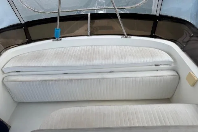 Slide: The Image of 1992 Mediterranean 38 Convertible boat interior with white cushioned seating. - 7