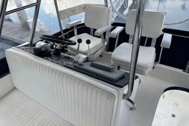 Slide: The Image of Cockpit of 1992 Mediterranean 38 Convertible yacht with white seating and control panel. - 8