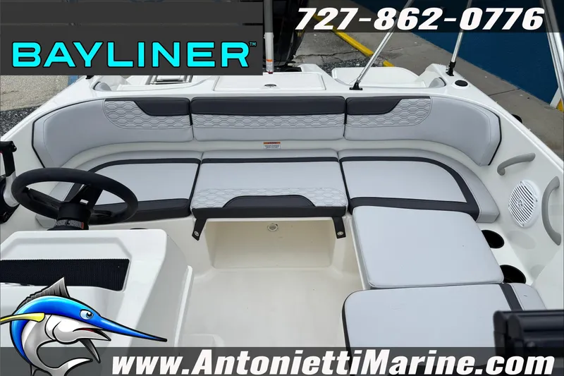 Slide: The Image of Bayliner Element E17 boat interior with seating, steering wheel, and marine logo. - 30