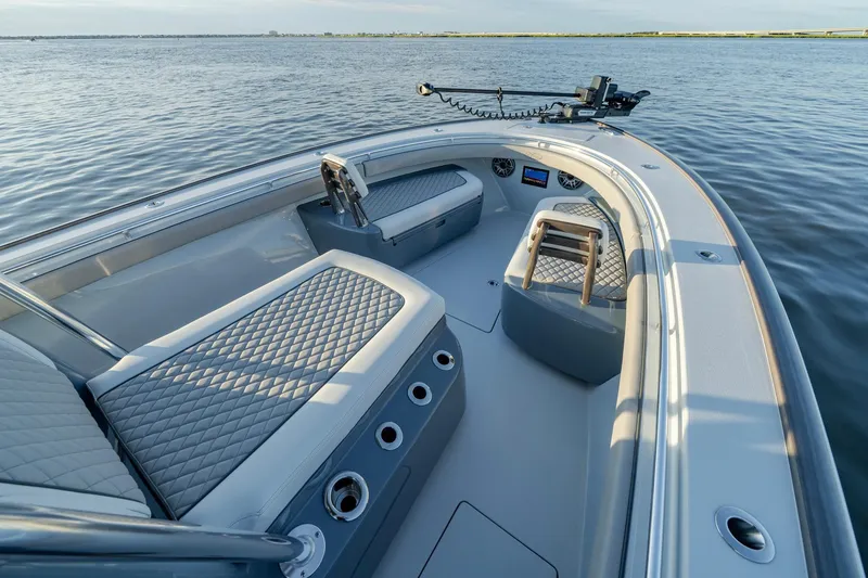 Slide: The Image of 2024 Valhalla Boatworks V-29 Hybrid interior with luxurious seating on calm water. - 10