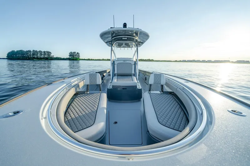 Slide: The Image of 2024 Valhalla Boatworks V-29 Hybrid on calm water, showcasing sleek design and luxurious seating. - 11