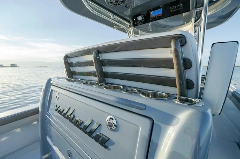 Slide: The Image of 2024 Valhalla Boatworks V-29 Hybrid, sleek design with cup holders, on calm water. - 28