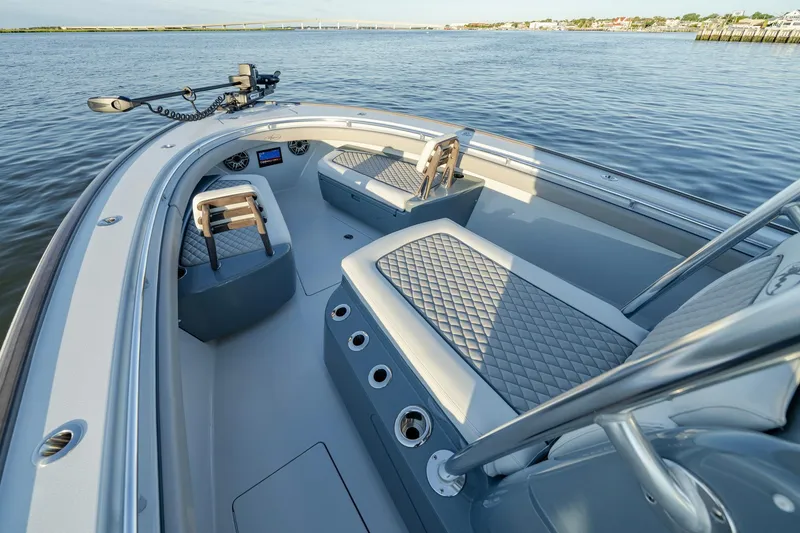 Slide: The Image of 2024 Valhalla Boatworks V-29 Hybrid interior with quilted seating on calm water. - 8