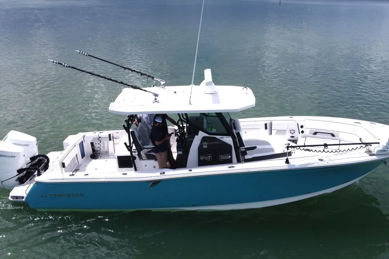 The Image of 2024 Blackfin 332 CC boat on water, featuring dual Mercury engines and fishing rods. - 0
