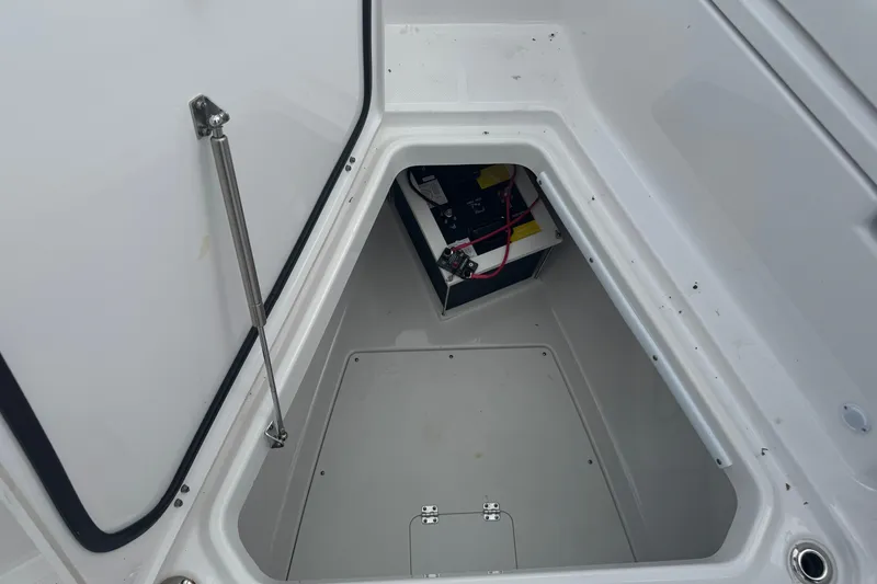 Slide: The Image of 2024 Blackfin 332 CC boat storage compartment with battery and wiring. - 13