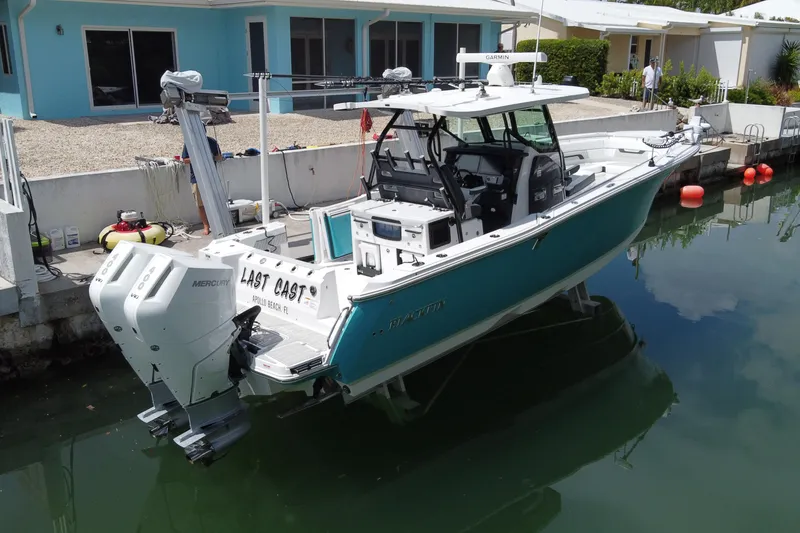 Slide: The Image of 2024 Blackfin 332 CC boat docked, featuring twin Mercury engines and modern design. - 4