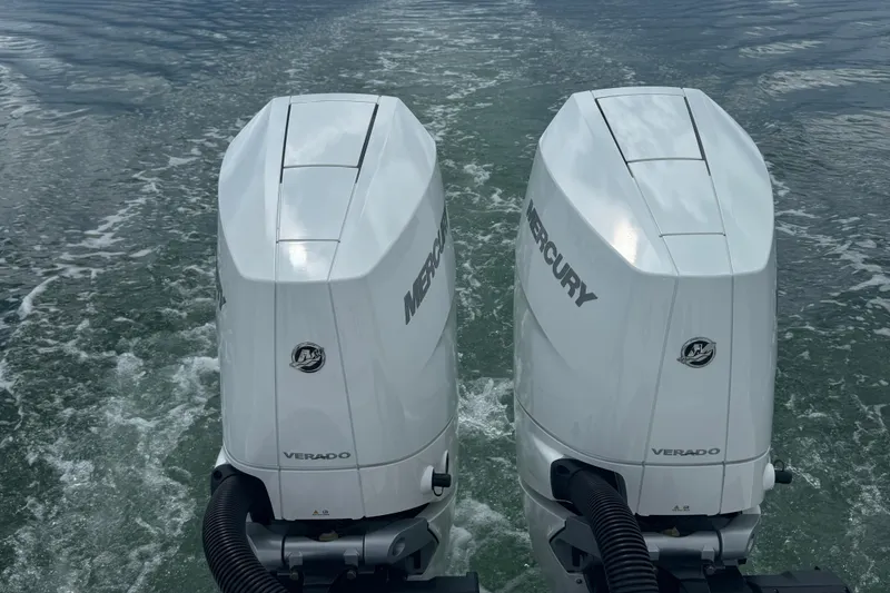Slide: The Image of Twin Mercury Verado engines on a 2024 Blackfin 332 CC boat, cruising on water. - 7