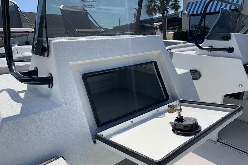 Slide: The Image of 2026 SeaArk Easy 200 boat dashboard with storage compartment and cup holder. - 13