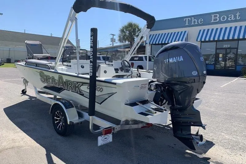 Slide: The Image of 2026 SeaArk Easy 200 boat with Yamaha motor, parked outside dealership. - 2