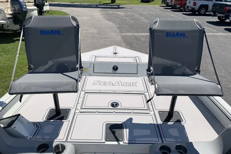 Slide: The Image of 2026 SeaArk Easy 200 boat deck with two seats, parked outdoors. - 22