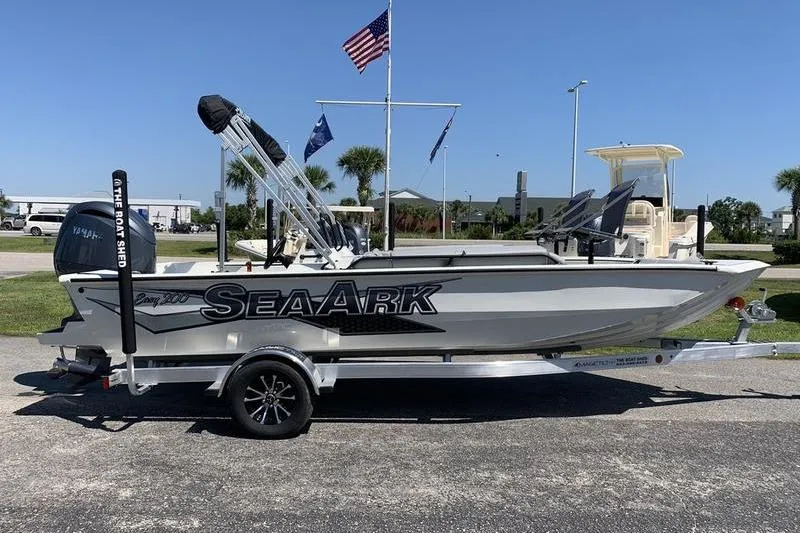 Slide: The Image of 2026 SeaArk Easy 200 boat on trailer, parked outdoors under clear blue sky. - 5