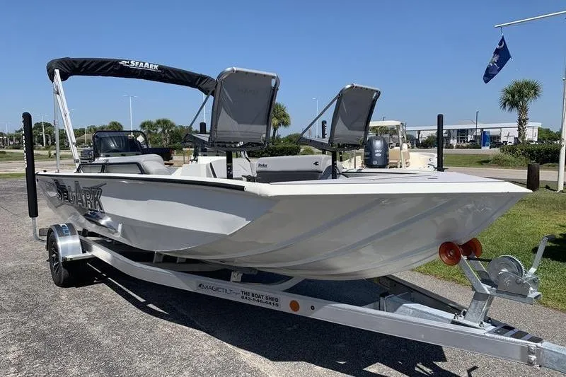 Slide: The Image of 2026 SeaArk Easy 200 boat on trailer, parked outdoors under clear blue sky. - 6