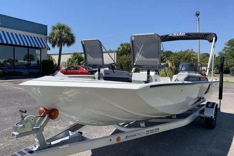 Slide: The Image of 2026 SeaArk Easy 200 boat on trailer, parked outdoors near a building. - 8