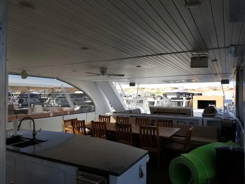 Slide: The Image of Luxurious Bravada yacht interior with dining area and kitchen, 2016 Epic Journey model. - 3