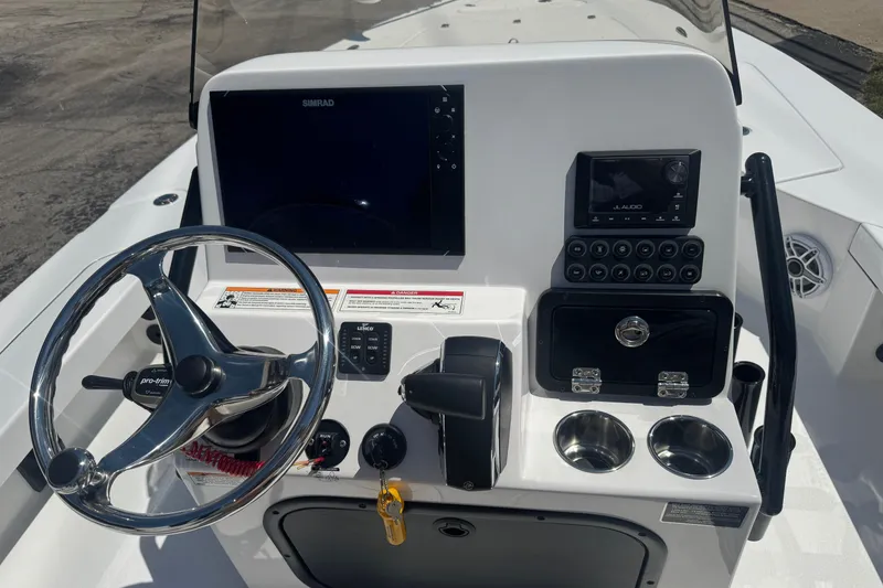 Slide: The Image of 2026 Blazer 675 Ultimate Bay boat console with steering wheel, controls, and navigation display. - 10